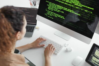A woman is coding at her desk.